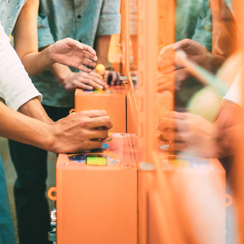 Close-up of people playing on arcade claw machines at Ormiston Town Centre.