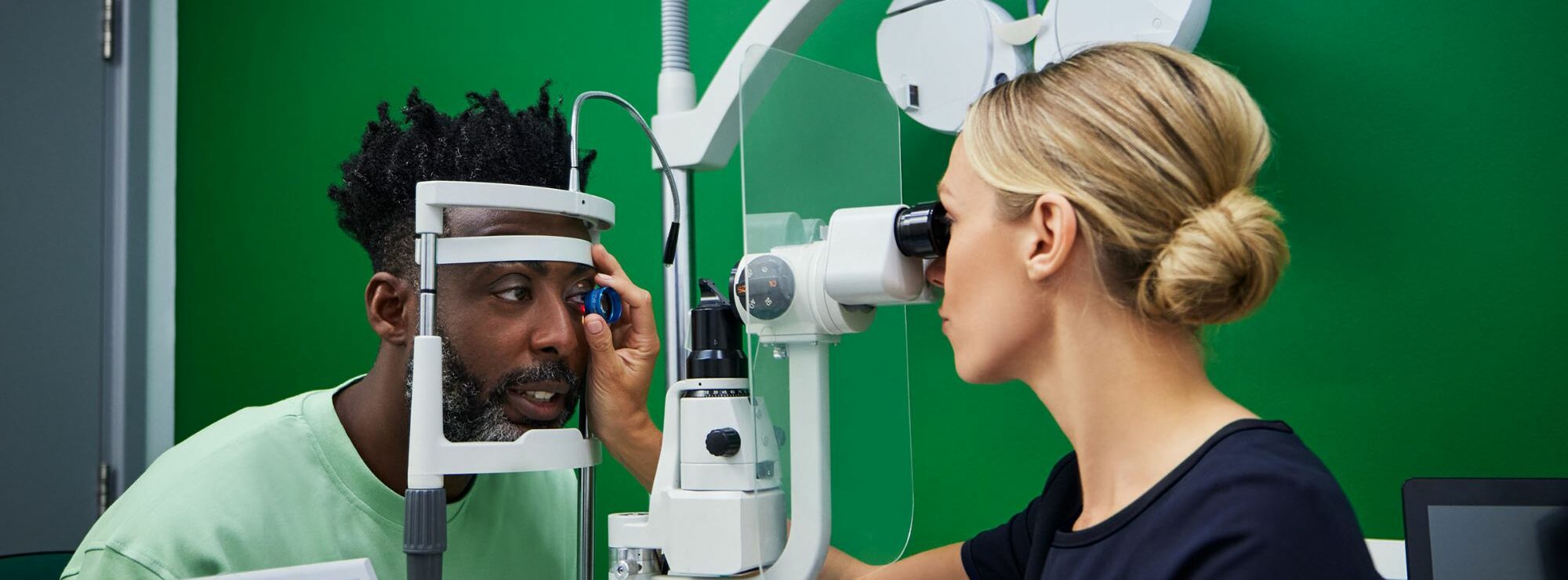 An eye doctor performing an advanced OCT 3D eye scan during a professional eye test at Specsavers